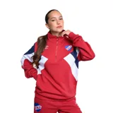 Buzo deportivo de mujer Umbro, con diseño de cuello alto y cierre frontal parcial. Presenta bloques de color en rojo, blanco y azul, con el escudo del Club Nacional de Football y el logo de la marca bordados en el pecho.