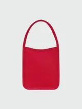 Cartera mini de mano con estructura rígida y asa superior redondeada, confeccionada en cuero de grano fino con acabado minimalista.