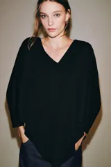 Camiseta tipo capa color negro de algodón Supima 100%, con escote en V, manga larga fluida y bajo asimétrico.