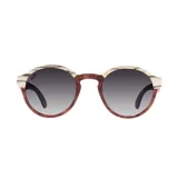 Lentes de sol Indie modelo Hill con montura redonda de madera color marrón y beige, y lentes grises degradadas.