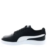 Championes Puma modelo Shuffle, de diseño urbano con silueta de bota baja. Presentan una parte superior de cuero sintético negro con la icónica franja lateral blanca y detalles en dorado. Incluyen perforaciones en la puntera para mayor ventilación y una suela de goma blanca.