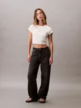 Remera de corte cropped y ajuste ceñido, confeccionada en tejido de algodón con elastano. Presenta cuello redondo, mangas cortas y el monograma de la marca estampado en el centro del pecho.