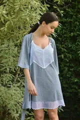 Camisón de algodón color beige con escote en V y ruedo decorados con puntilla gris. Presenta breteles finos y corte recto.