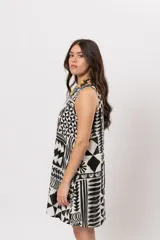 Vestido corto sin mangas con silueta acampanada y cuello cerrado, con estampado geométrico en blanco y negro.
