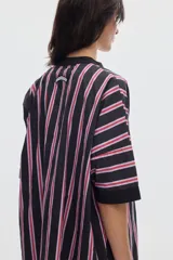 Vestido corto de algodón con estampa de lunares, cuello mao y cierre frontal con botones. Presenta un diseño holgado de mangas cortas.