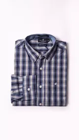 Camisa de manga larga Brooksfield con diseño de cuadros en tonos azules, blancos y negros. Presenta cuello clásico, cierre frontal con botones y logo bordado en el pecho.
