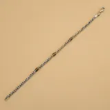 Pulsera de plata con eslabones trenzados y apliques de doble oro.