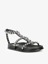 Sandalias negras con tiras adornadas con tachas plateadas de diferentes tamaños, cierre de velcro en el tobillo y suela sintética.