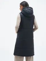 Chaleco largo acolchado color negro con capucha y cierre frontal.