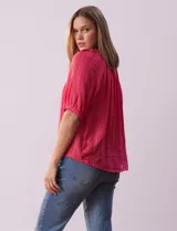 Blusa color fucsia con estampado de rayas verticales y flores, cuello redondo con escote en V y mangas cortas abullonadas.