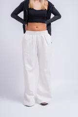 Pantalón cargo color beige, de corte ancho y tiro alto, con bolsillos laterales con solapa y cintura elástica.