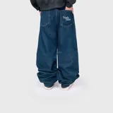 Jean de corte ultra baggy confeccionado en denim de algodón color azul, con diseño holgado y bolsillos traseros con bordado decorativo.