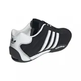 Championes Adidas modelo Adi Racer Lo, de diseño inspirado en el automovilismo. Presentan una base de gamuza negra con las icónicas tres tiras laterales en color plateado y detalles metálicos en el talón. Incluyen suela de goma con logo Adidas en el lateral.