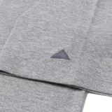 Remera tipo polo de manga corta, confeccionada en tejido piqué color gris jaspeado. Presenta cuello y puños acanalados, cierre frontal con botones grabados con el logo de la marca, logo Cat estampado en el pecho y detalle bordado en forma de triángulo en la manga.