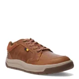 Zapatos urbanos Caterpillar modelo Apa Cush, confeccionados en cuero y gamuza color marrón. Presentan cierre con cordones, entresuela de EVA para mayor amortiguación y diseño de costuras reforzadas.