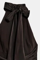 Vestido corto de cuello halter con espalda descubierta, diseño con frunces en el cuerpo y bajo con lentejuelas brillantes. Cuenta con forro interior y cierre trasero con cremallera oculta.