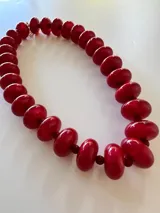 Collar de cuentas redondas y aplanadas con efecto marmolado en tonos grisáceos, con cierre metálico dorado.