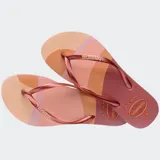 Ojotas Havaianas Slim Palette Glow con base estampada en tonos rosa, naranja y marrón, tiras finas color cobre y logo de la marca en las tiras.