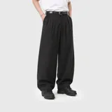 Pantalon sastrero de corte amplio y tiro alto, color negro, con pinzas frontales, bolsillos laterales y cierre con botón y cremallera.
