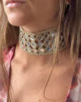 Gargantilla dorada con espejos cuadrados y circulares.