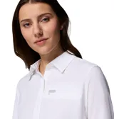 Camisa de manga larga Columbia en color blanco, diseñada con tecnología Omni-Shade y Omni-Wick. Presenta cuello clásico, cierre frontal con botones y un bolsillo en el pecho con etiqueta de la marca.