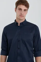 Camisa azul marino de manga larga con cuello abotonado y bolsillo en el pecho.