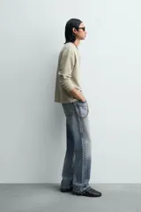 Camiseta de manga larga para hombre con corte relajado, confeccionada en tejido con estructura waffle. Presenta un cuello redondo tipo panadero con cierre frontal de botones a presión.