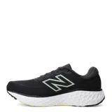 Championes de running New Balance Evoz Fresh Foam para hombre, color negro con entresuela blanca y suela negra con detalles amarillos. Presentan el logotipo 'N' en los laterales en color verde claro y tecnología Fresh Foam en la entresuela para mayor amortiguación.