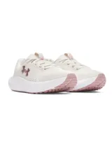 Championes de running Under Armour modelo Charged Surge 4, color beige con detalles en rosado. Presentan parte superior de malla transpirable, entresuela Charged Cushioning para mayor amortiguación y suela de goma resistente.