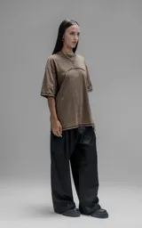 Remera de manga corta con calce oversize, confeccionada en algodón con proceso batik artesanal. Presenta recortes superpuestos y costuras expuestas en el frente, espalda y mangas.