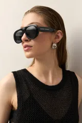 Vestido de tejido con trama abierta y caída liviana, confeccionado en un hilado con acabado metalizado. Silueta recta y sin mangas.