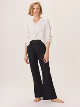 Pantalón negro de algodón, con corte recto, costura central en la pierna, bolsillos con pespuntes irregulares y pasacintos.