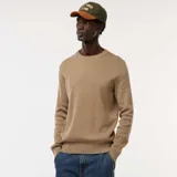 Sweater de punto con textura fantasía, cuello redondo y mangas largas con puños acanalados.