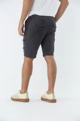 Bermuda cargo de corte recto, color gris oscuro, con bolsillos laterales tipo cargo, cierre de cremallera y botón, y pasacintos en la cintura.