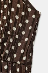 Vestido midi de color marrón con estampado de lunares blancos, cuello halter con lazo y diseño plisado.