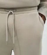 Pantalón de corte recto confeccionado en tejido de algodón y poliéster, con cintura elástica, cordón de ajuste y bolsillos laterales.