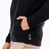 Buzo polar de mujer con cuello alto y cierre frontal parcial con botones a presión. Presenta un diseño de manga larga con puños elásticos y un parche con logo en el pecho.