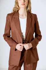 Blazer color crema con solapas de muesca, cierre frontal con dos botones y mangas largas con puños abotonados.