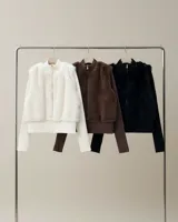 Campera de mujer con diseño híbrido, combinando cuerpo de símil piel de pelo corto y mangas, cuello y pretina en tejido de punto rib acanalado. Presenta cuello alto, cierre frontal metálico y corte a la cadera.