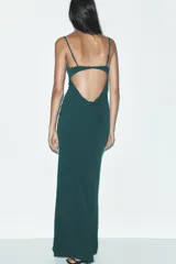 Vestido largo verde esmeralda de tirantes finos ajustables y escote fluido drapeado. Tiene forro interior y cierre trasero con gancho metálico.