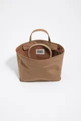 Bolso shopper mediano de mano Bimba y Lola color marrón, confeccionado en poliamida con detalles en cuero y herrajes metálicos dorados. Cuenta con doble asa de mano, correa de hombro ajustable de lona beige, cierre superior con cremallera y logo impreso en dorado al frente.