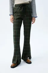 Pantalón acampanado a cuadros en tonos azul, marrón y negro, con cintura elástica y cordón ajustable.