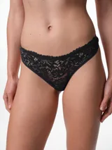 Bombacha tipo colaless de encaje blanco con diseño floral, de tiro medio y fundillo de algodón.