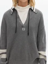 Sweater marrón de punto con cuello polo, escote en V y mangas largas con puños acanalados.