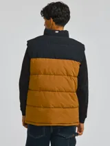 Chaleco acolchado Caterpillar con diseño bicolor en negro y marrón, cierre frontal completo, cuello alto y bolsillos laterales con cierre.