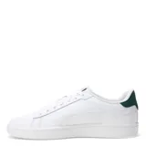 Championes Puma modelo Smash 3.0 L, de diseño urbano en color blanco con detalles en dorado y verde oscuro en el talón. Confeccionados en cuero sintético con cierre de cordones y suela de goma.