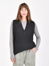 Chaleco de punto negro con cuello en V acanalado, sin mangas y corte recto.
