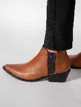Botines marrones de cuero con elástico lateral negro, punta fina y taco bajo.