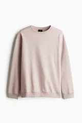 Buzo rosa de tejido liviano de mezcla de algodón con interior cepillado suave, cuello redondo ribeteado, hombros caídos y remate ancho acanalado en puños y bajo. Corte holgado.