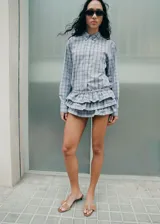 Camisa oversize de algodón con estampado a cuadros, cuello camisero, cierre frontal de botones y mangas largas.